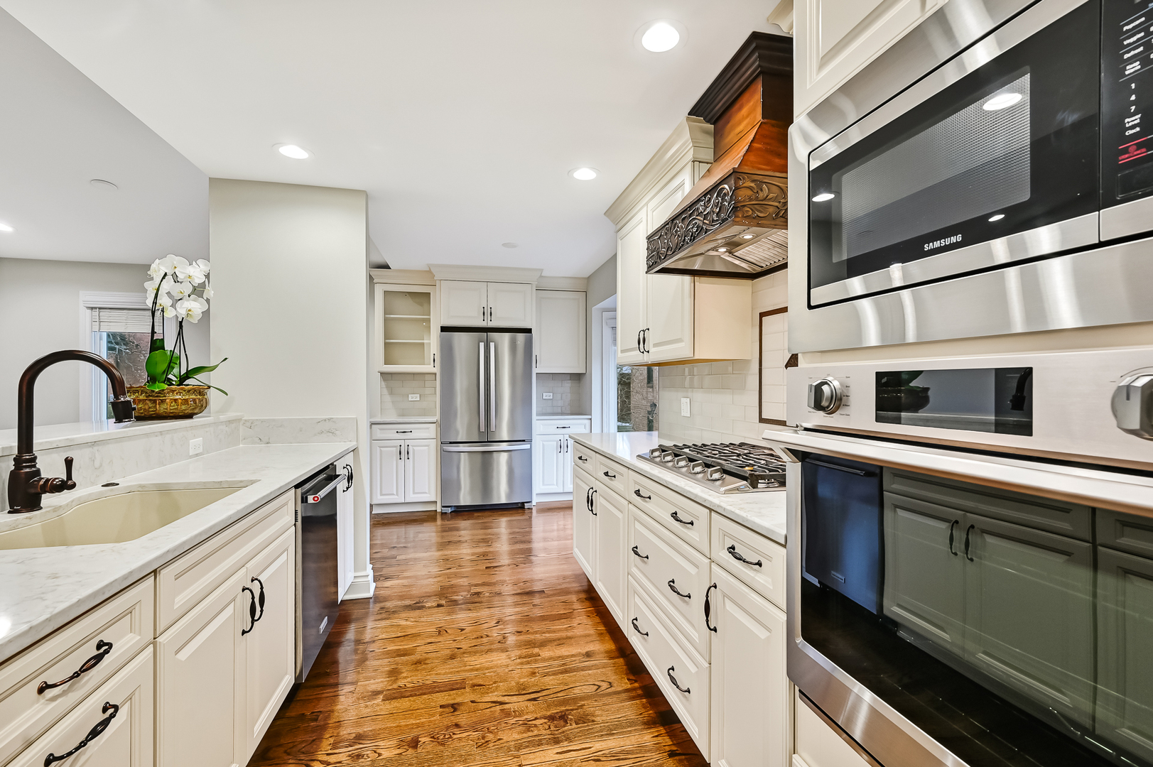 2-s719 Williamsburg Court Oak Brook, IL 60523 - Photo 17 of 48 a kitchen with stainless steel appliances granite countertop a sink and stove top oven