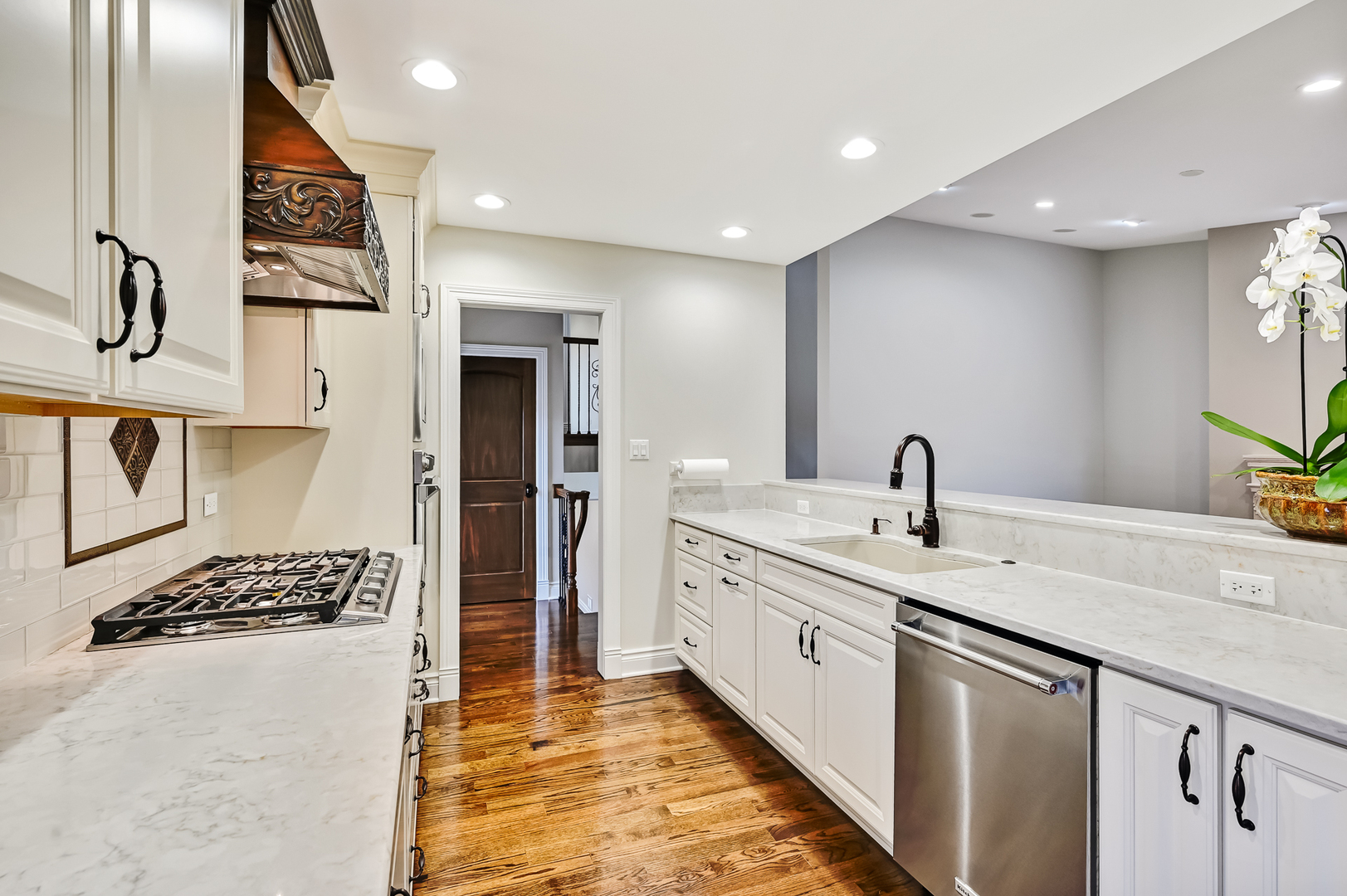 2-s719 Williamsburg Court Oak Brook, IL 60523 - Photo 18 of 48 a kitchen with stainless steel appliances granite countertop a sink and cabinets