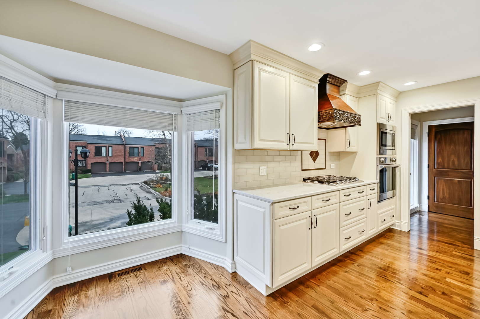 2-s719 Williamsburg Court Oak Brook, IL 60523 - Photo 20 of 48 a kitchen with stainless steel appliances granite countertop a stove a sink and a refrigerator