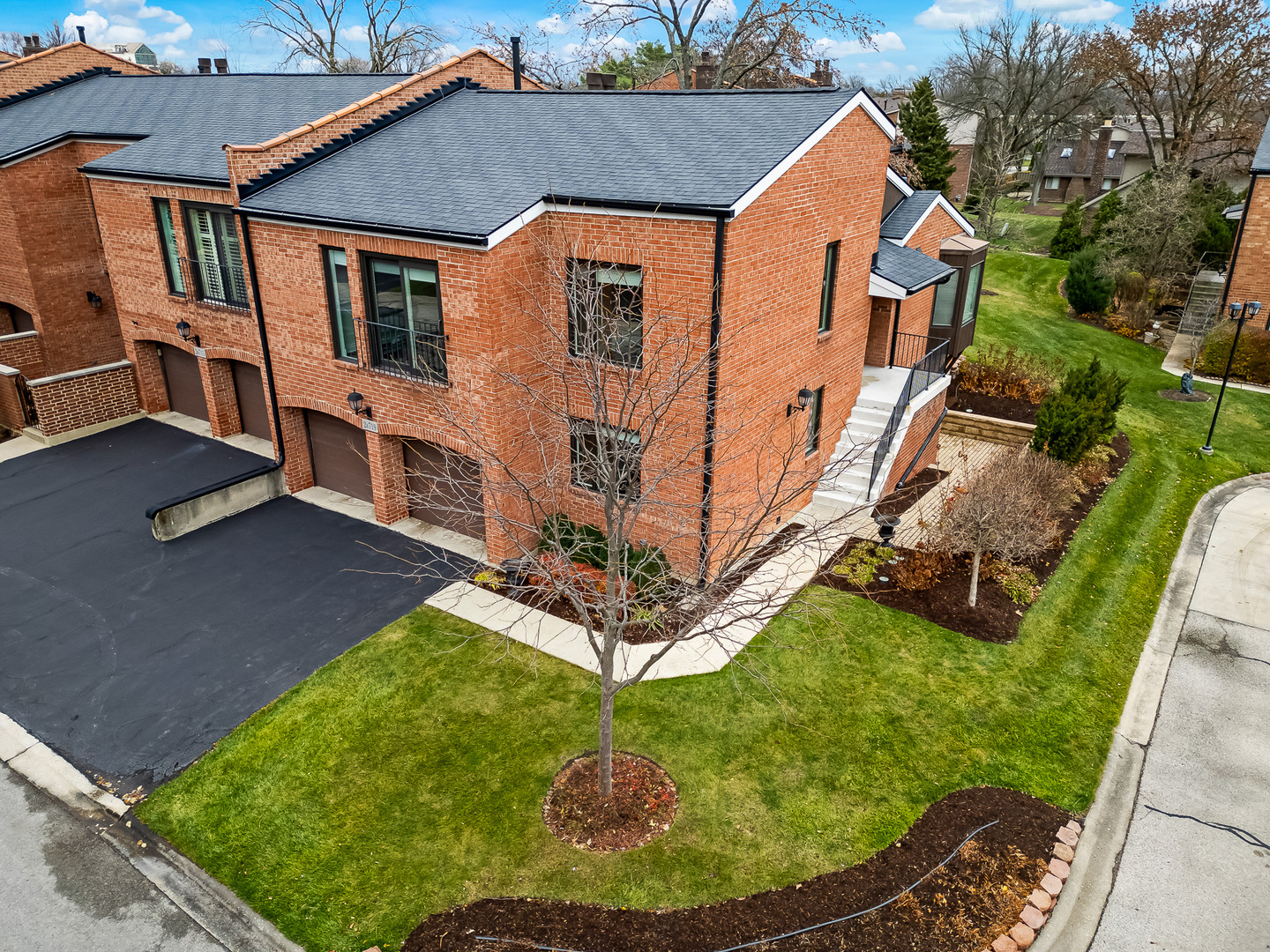 2-s719 Williamsburg Court Oak Brook, IL 60523 - Photo 2 of 48 a view of a house with backyard