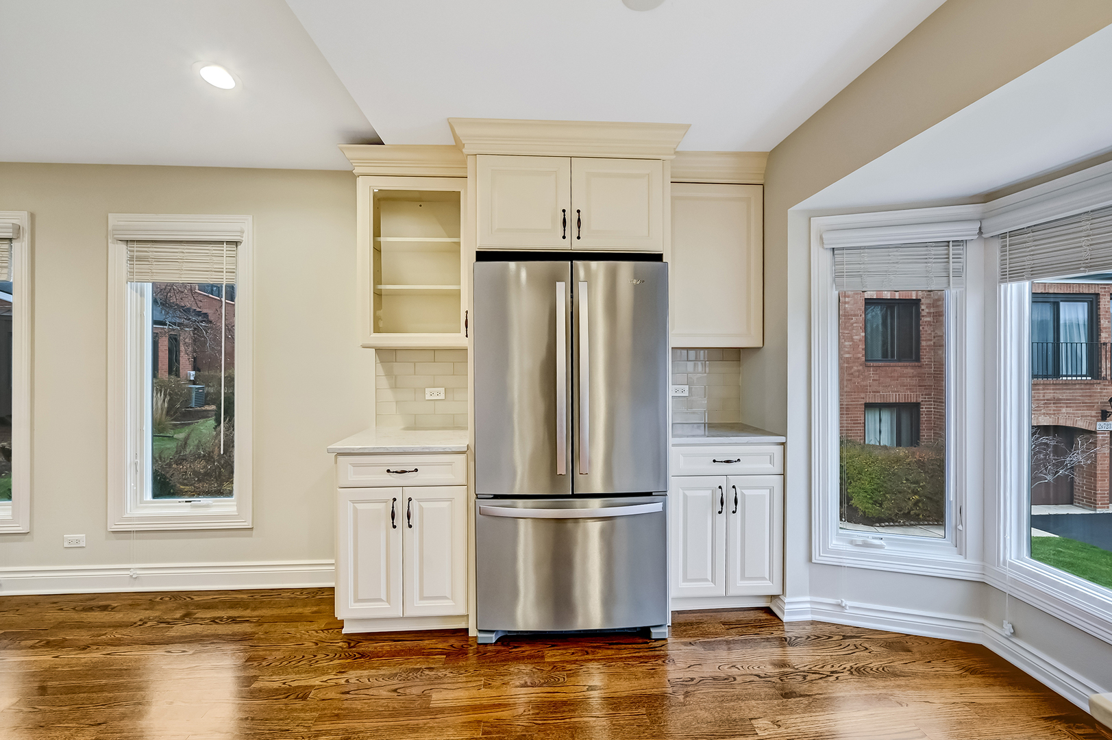 2-s719 Williamsburg Court Oak Brook, IL 60523 - Photo 21 of 48 a view of kitchen with stainless steel appliances wooden floor and window