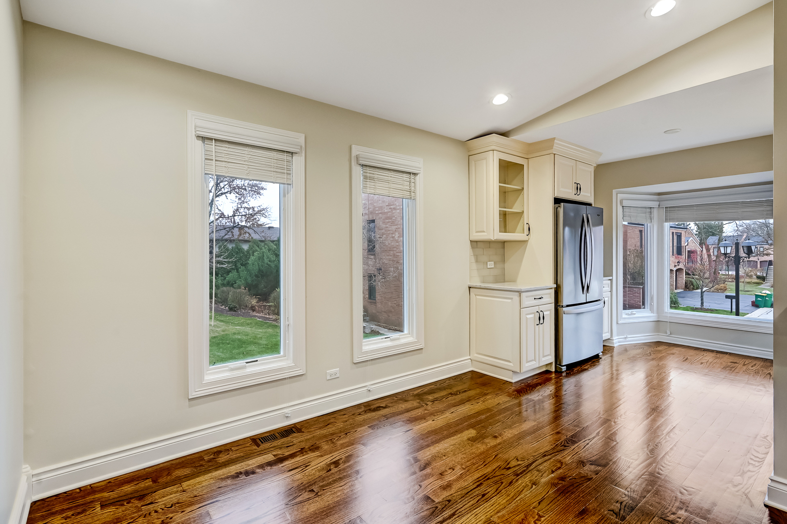 2-s719 Williamsburg Court Oak Brook, IL 60523 - Photo 22 of 48 a view of a refrigerator in kitchen and wooden floor
