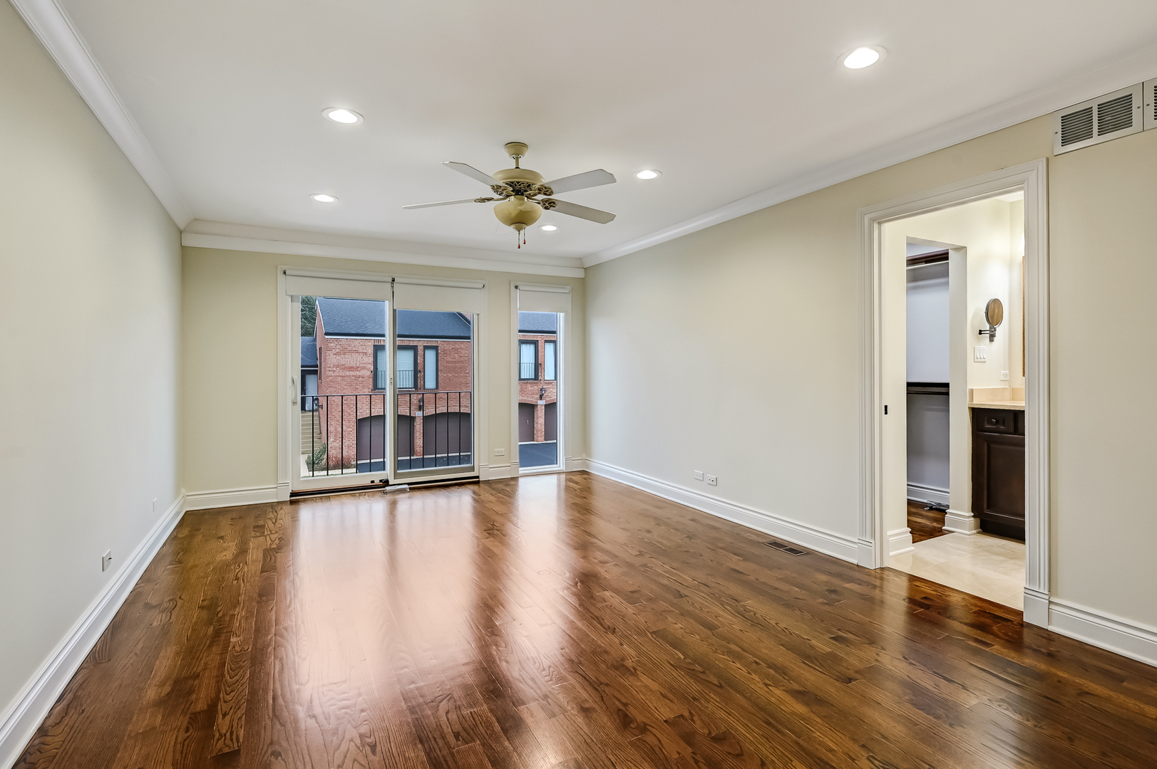 2-s719 Williamsburg Court Oak Brook, IL 60523 - Photo 25 of 48 a view of empty room with wooden floor and fan