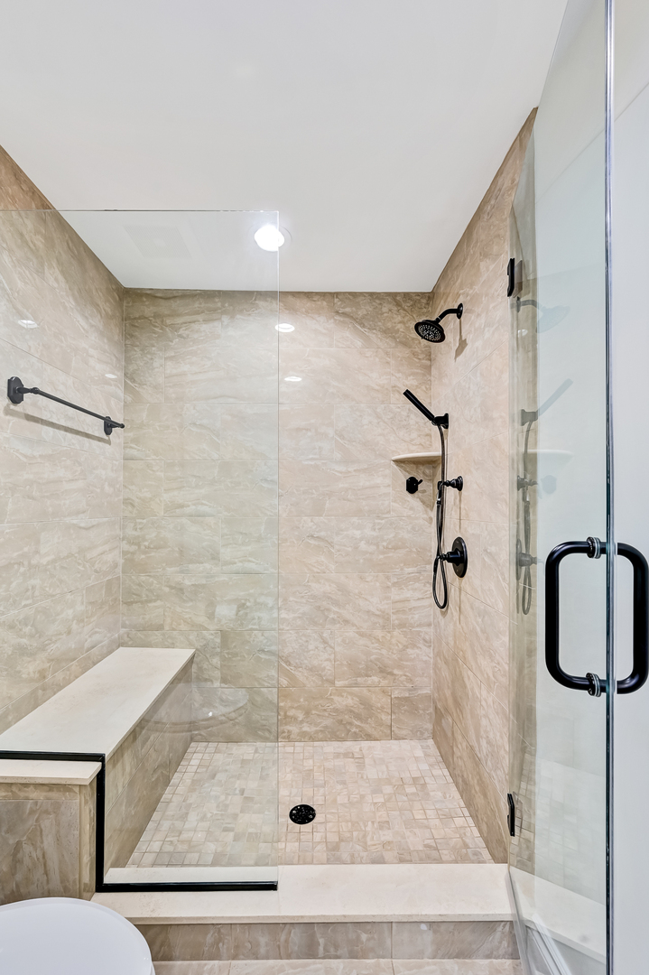 2-s719 Williamsburg Court Oak Brook, IL 60523 - Photo 27 of 48 a bathroom with a shower