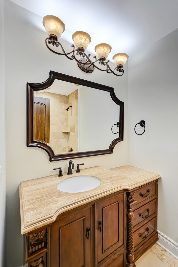 2-s719 Williamsburg Court Oak Brook, IL 60523 - Photo 31 of 48 a bathroom with a sink vanity and a mirror