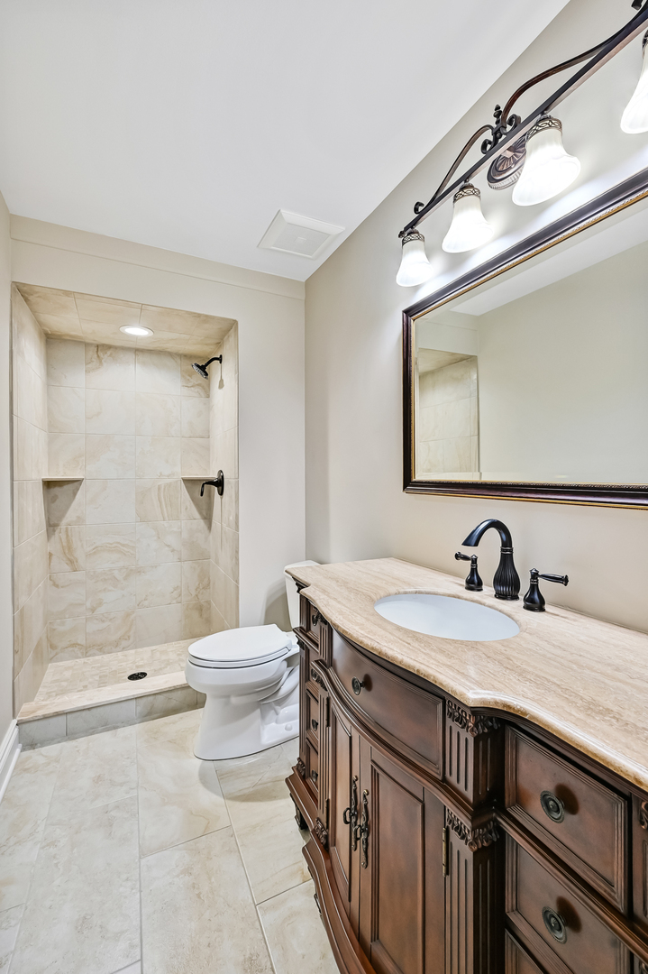 2-s719 Williamsburg Court Oak Brook, IL 60523 - Photo 34 of 48 a bathroom with a sink a toilet and shower