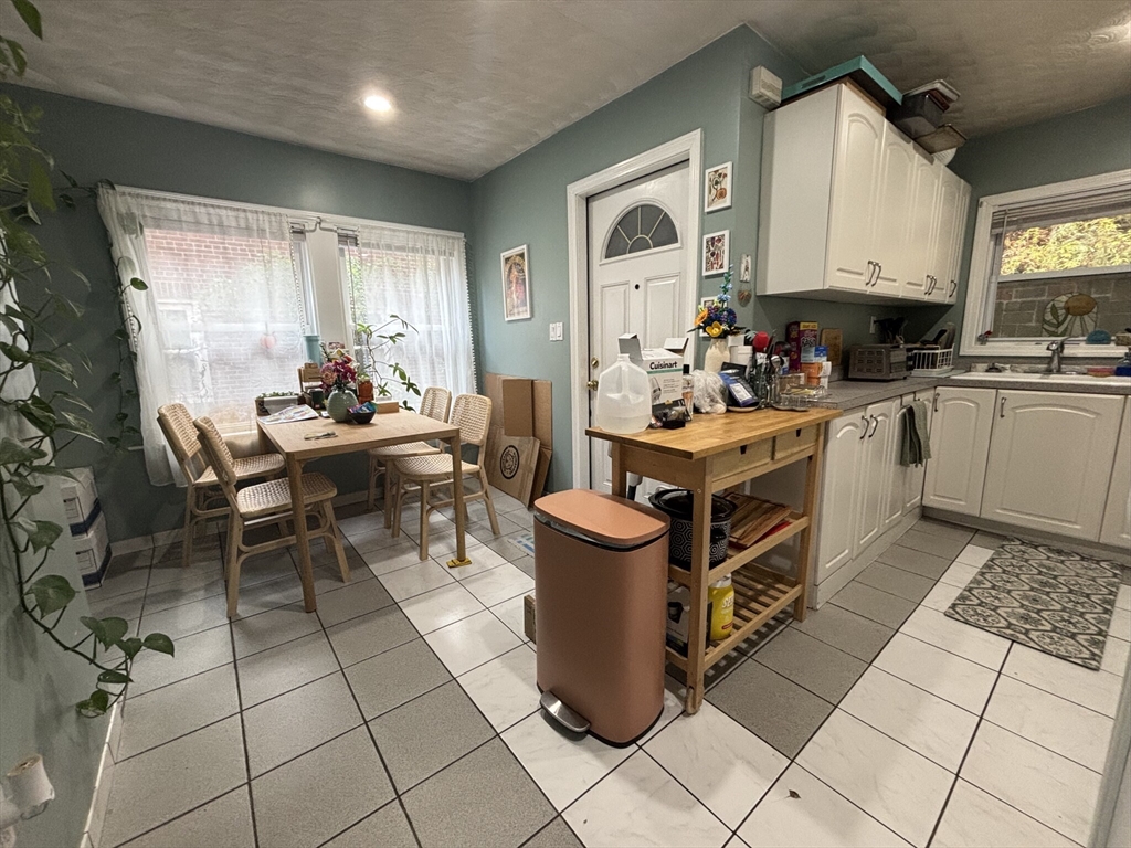 504 Washington Street, Unit 1 Brookline, MA 02446 - Photo 1 of 13 a kitchen with a stove a sink and a refrigerator