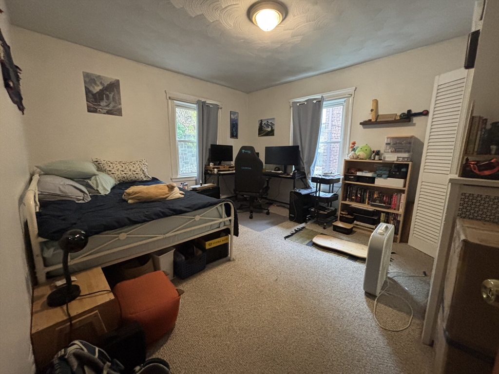 504 Washington Street, Unit 1 Brookline, MA 02446 - Photo 12 of 13 a living room with furniture gym equipment and a flat screen tv