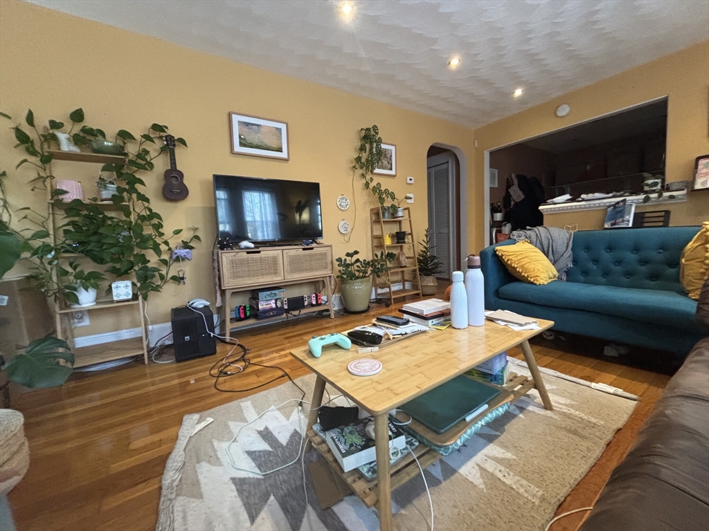 504 Washington Street, Unit 1 Brookline, MA 02446 - Photo 8 of 13 a living room with fireplace furniture and a flat screen tv