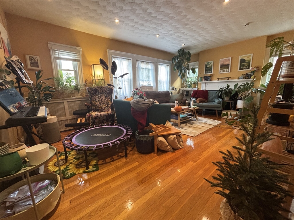 504 Washington Street, Unit 1 Brookline, MA 02446 - Photo 9 of 13 a living room with furniture and a flat screen tv