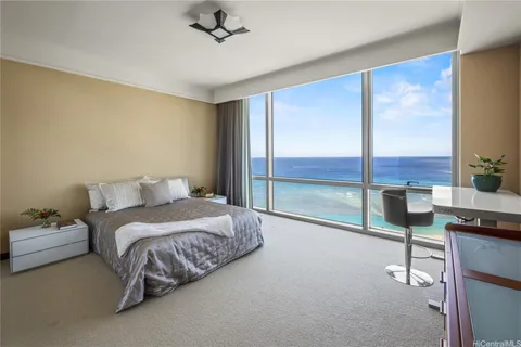 a spacious bedroom with a bed and large window