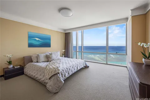 a spacious bedroom with a large bed and a large window