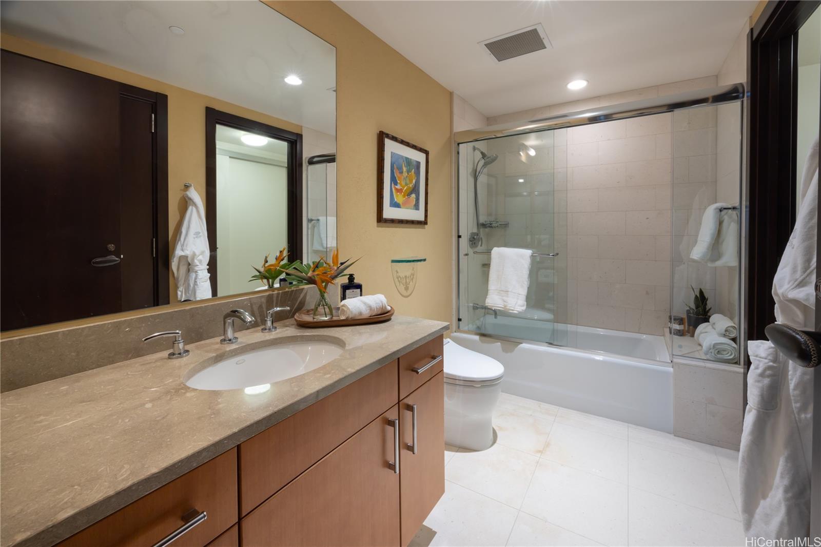 1288 Ala Moana Boulevard, Unit 37I Honolulu, HI 96814 - Photo 15 of 24 a bathroom with a double vanity sink toilet mirror and bathtub
