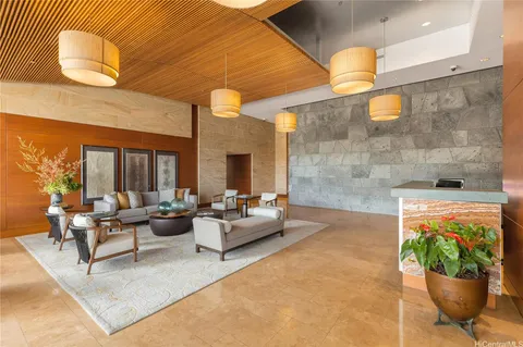 a lobby with furniture and a potted plant