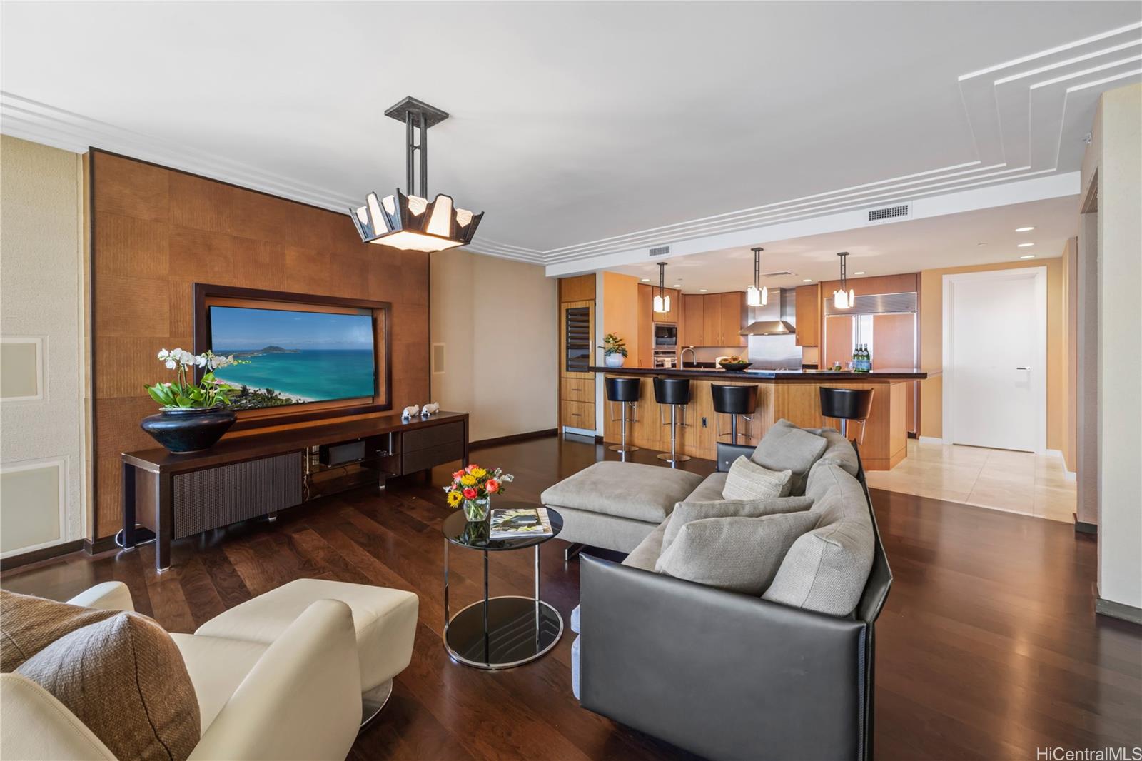 1288 Ala Moana Boulevard, Unit 37I Honolulu, HI 96814 - Photo 2 of 24 a living room with furniture and a flat screen tv