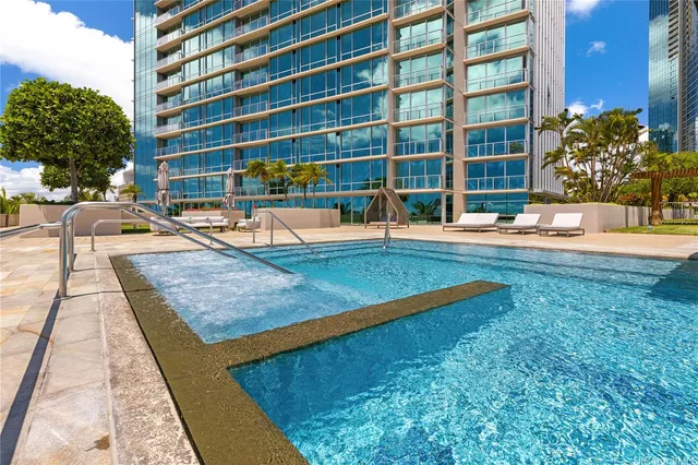 a view of a swimming pool with a lounge chairs