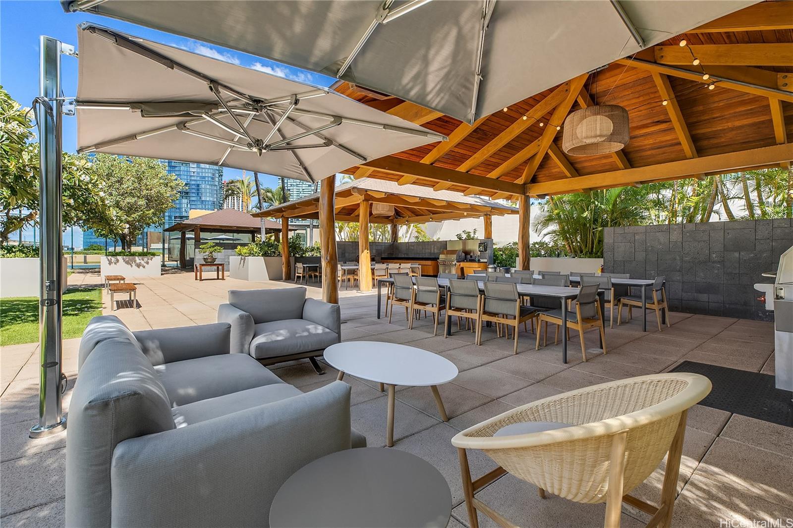 1288 Ala Moana Boulevard, Unit 37I Honolulu, HI 96814 - Photo 23 of 24 a view of a patio with a table and chairs under an umbrella