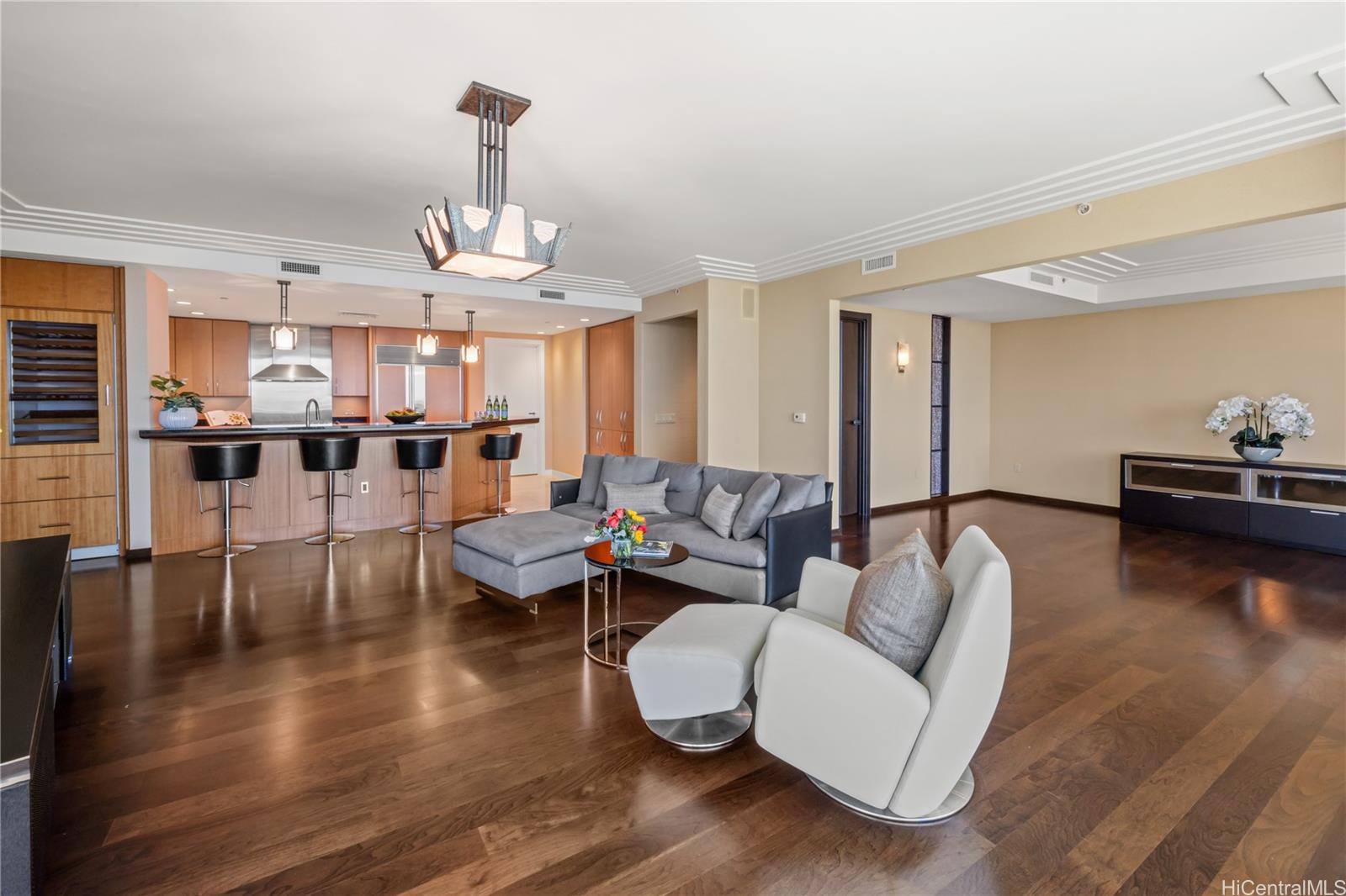 1288 Ala Moana Boulevard, Unit 37I Honolulu, HI 96814 - Photo 5 of 24 a living room with fireplace furniture and a wooden floor