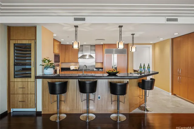 a kitchen with a dining table chairs sink and cabinets