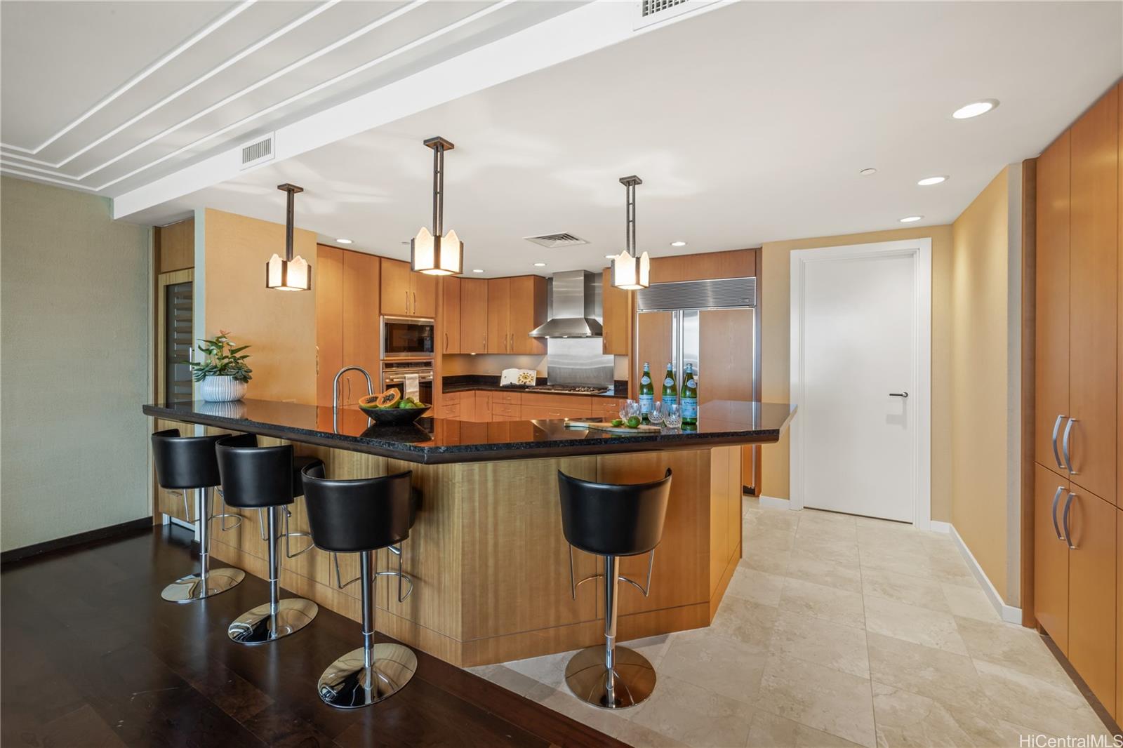 1288 Ala Moana Boulevard, Unit 37I Honolulu, HI 96814 - Photo 7 of 24 a kitchen with stainless steel appliances granite countertop a stove a sink dishwasher and a refrigerator with wooden floor