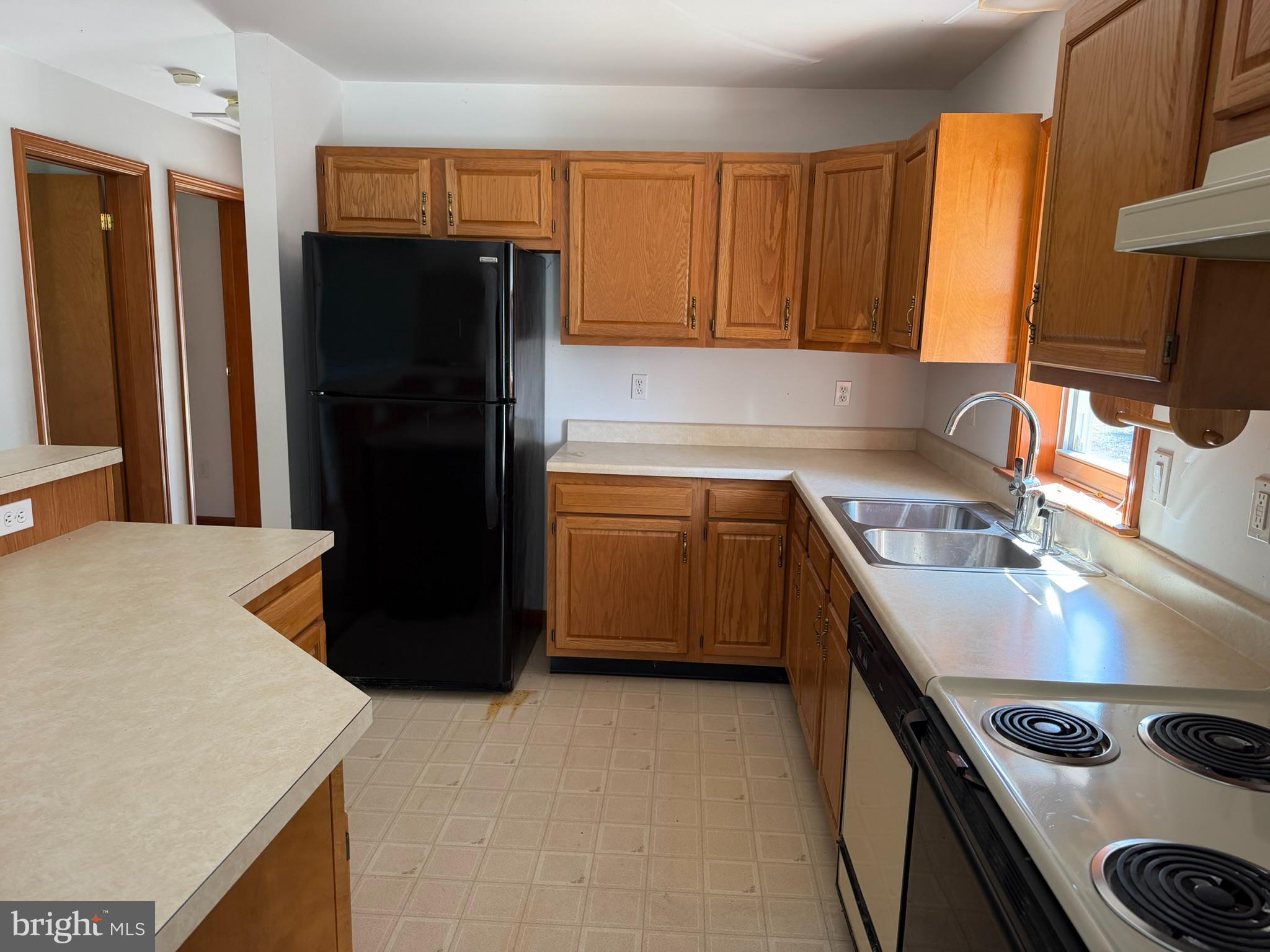 261 Andrews Lake Road Felton, DE 19943 - Photo 13 of 21 a kitchen with a sink a stove and refrigerator