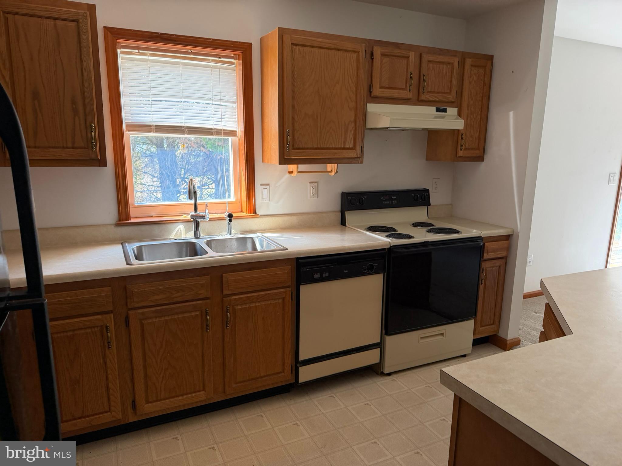 261 Andrews Lake Road Felton, DE 19943 - Photo 14 of 21 a kitchen with stainless steel appliances granite countertop a sink stove and cabinets