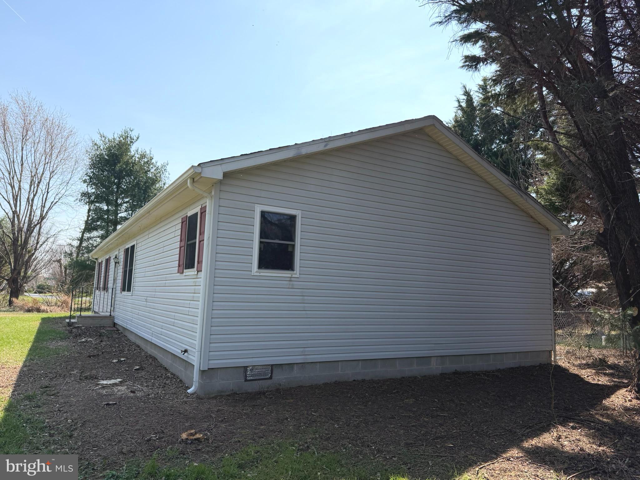 261 Andrews Lake Road Felton, DE 19943 - Photo 2 of 21 a view of a small white house with a small yard and large tree