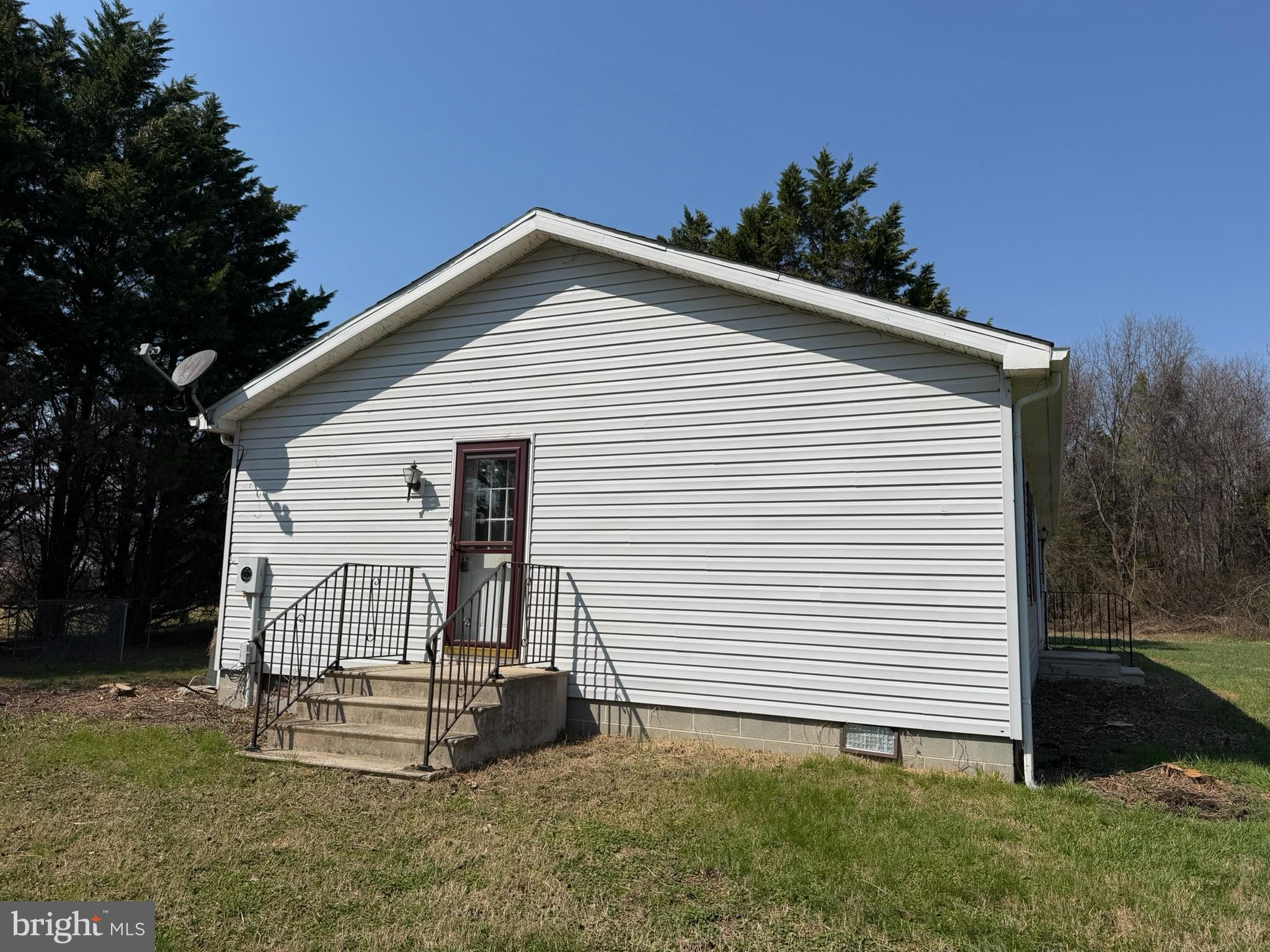 261 Andrews Lake Road Felton, DE 19943 - Photo 3 of 21 a white house with a small yard and a large window