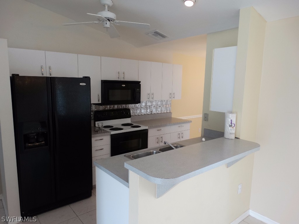 7227 Coolidge Road Fort Myers, FL 33967 - Photo 12 of 24 a kitchen with stainless steel appliances a refrigerator and a stove top oven