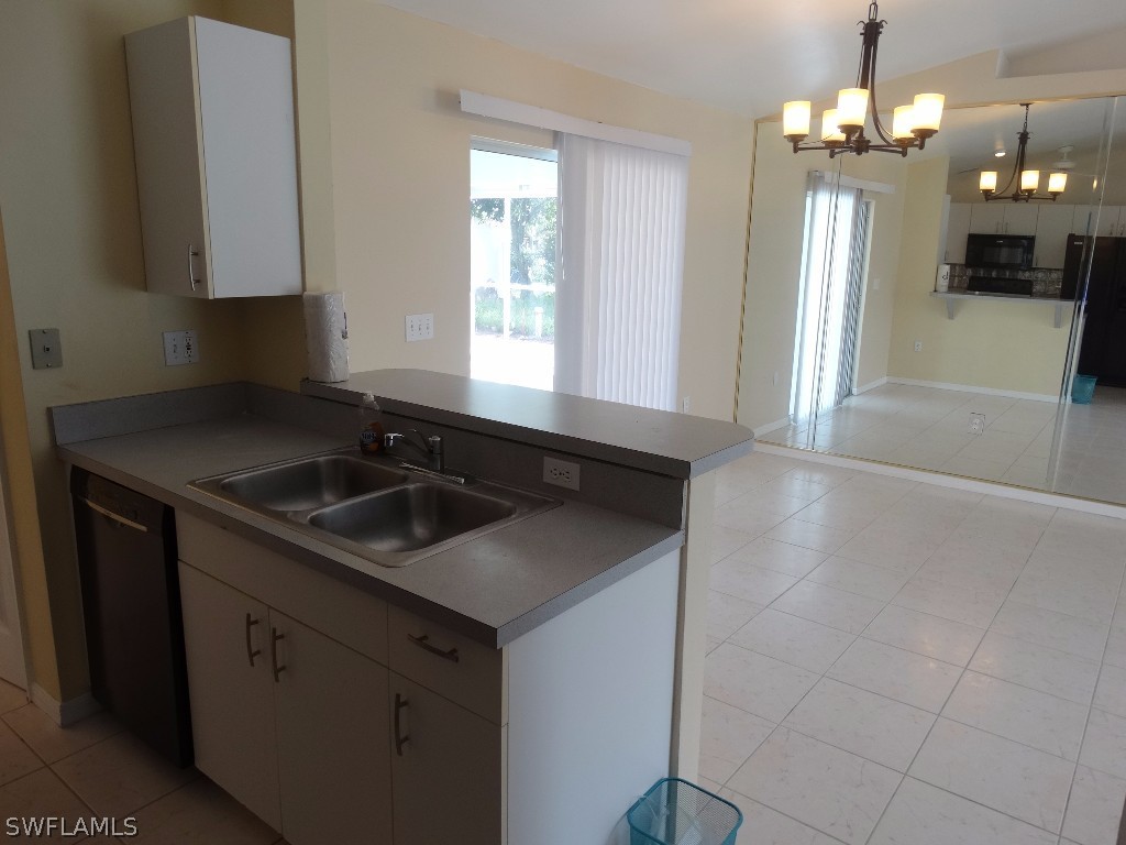 7227 Coolidge Road Fort Myers, FL 33967 - Photo 6 of 24 a kitchen with a sink stove and cabinets