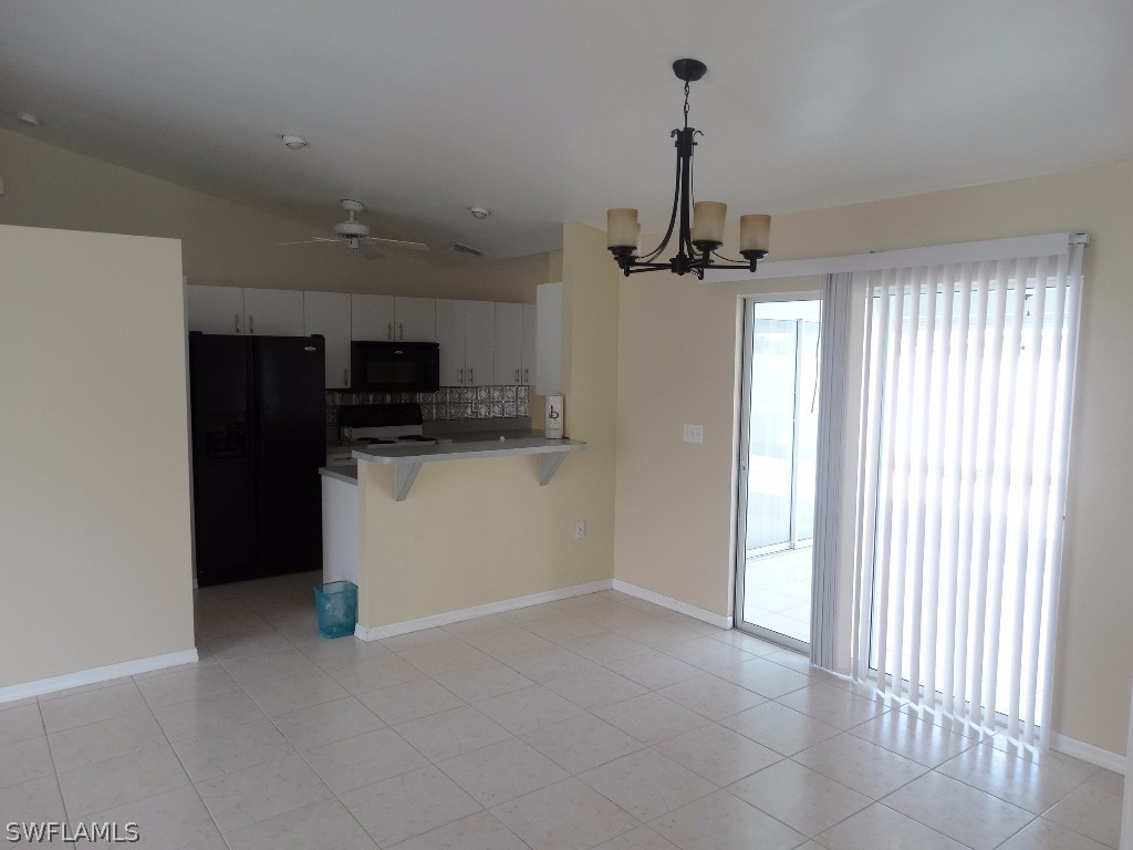 7227 Coolidge Road Fort Myers, FL 33967 - Photo 8 of 24 a view of a kitchen with a sink and dishwasher a refrigerator with wooden floor