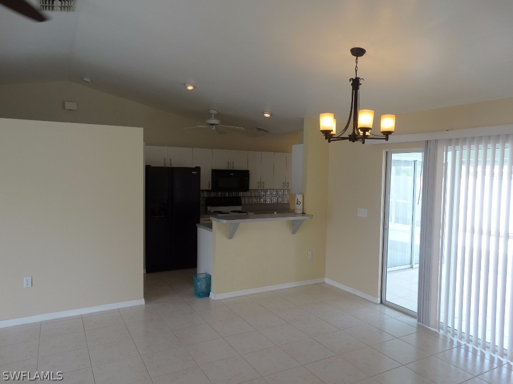 7227 Coolidge Road Fort Myers, FL 33967 - Photo 10 of 24 a view of empty room with a flat screen tv and a ceiling fan