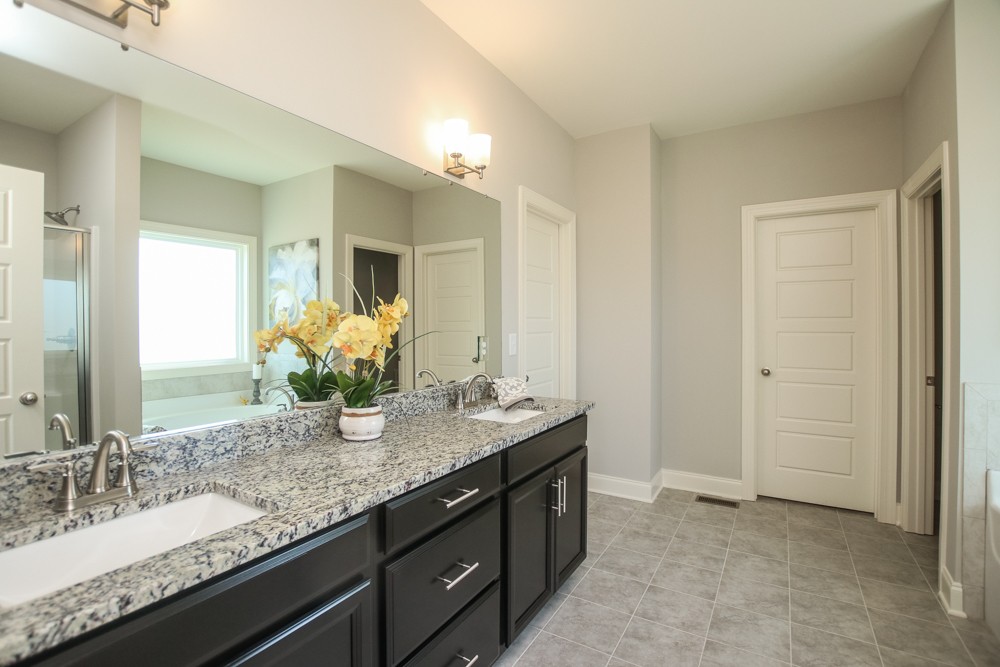 3865 Gwynn Road Lebanon, TN 37090 - Photo 22 of 40 a bathroom with a granite countertop double vanity sink and a mirror