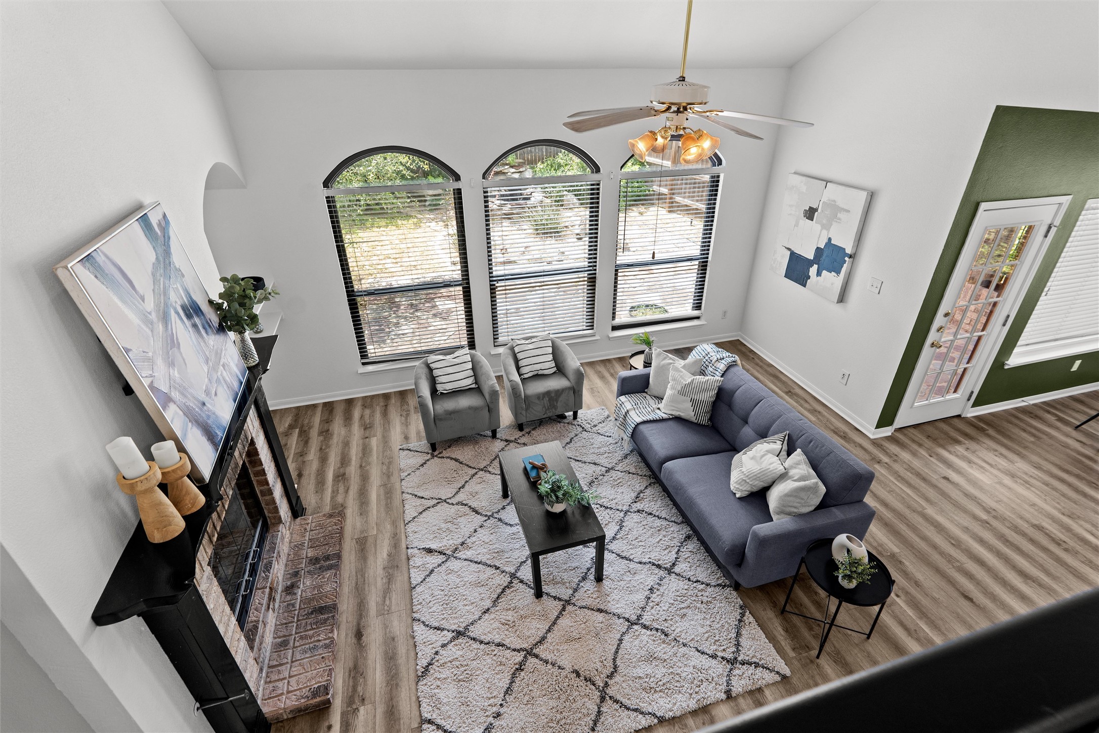 7000 Colberg Court Austin, TX 78749 - Photo 12 of 40 A spacious living area with high ceilings, large arched windows, and a classic fireplace.
