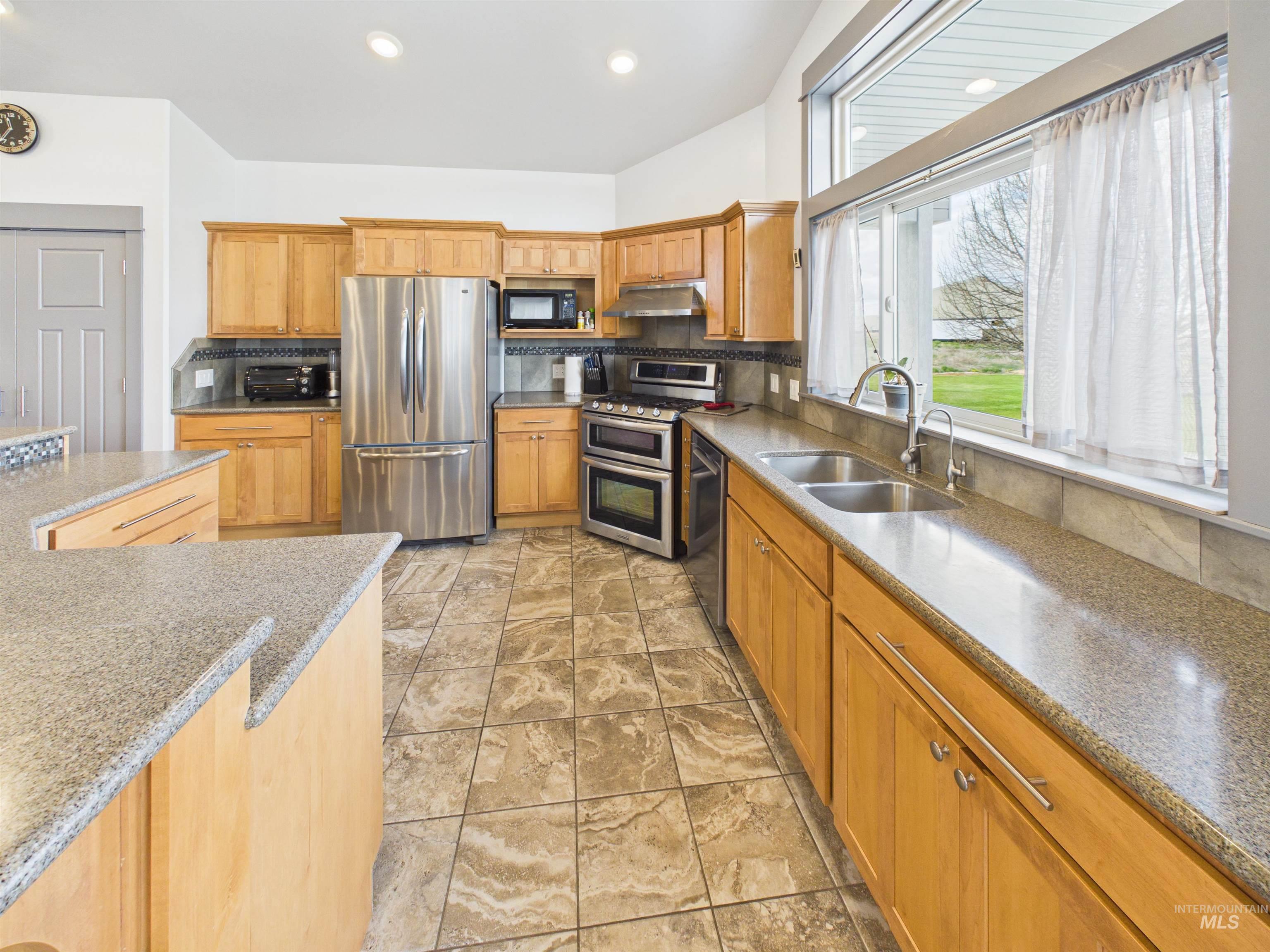 503 Heron Way Rupert, ID 83350 - Photo 11 of 49 Kitchen with stainless steel appliances, light stone countertops, wood finish cabinets, and recessed lighting