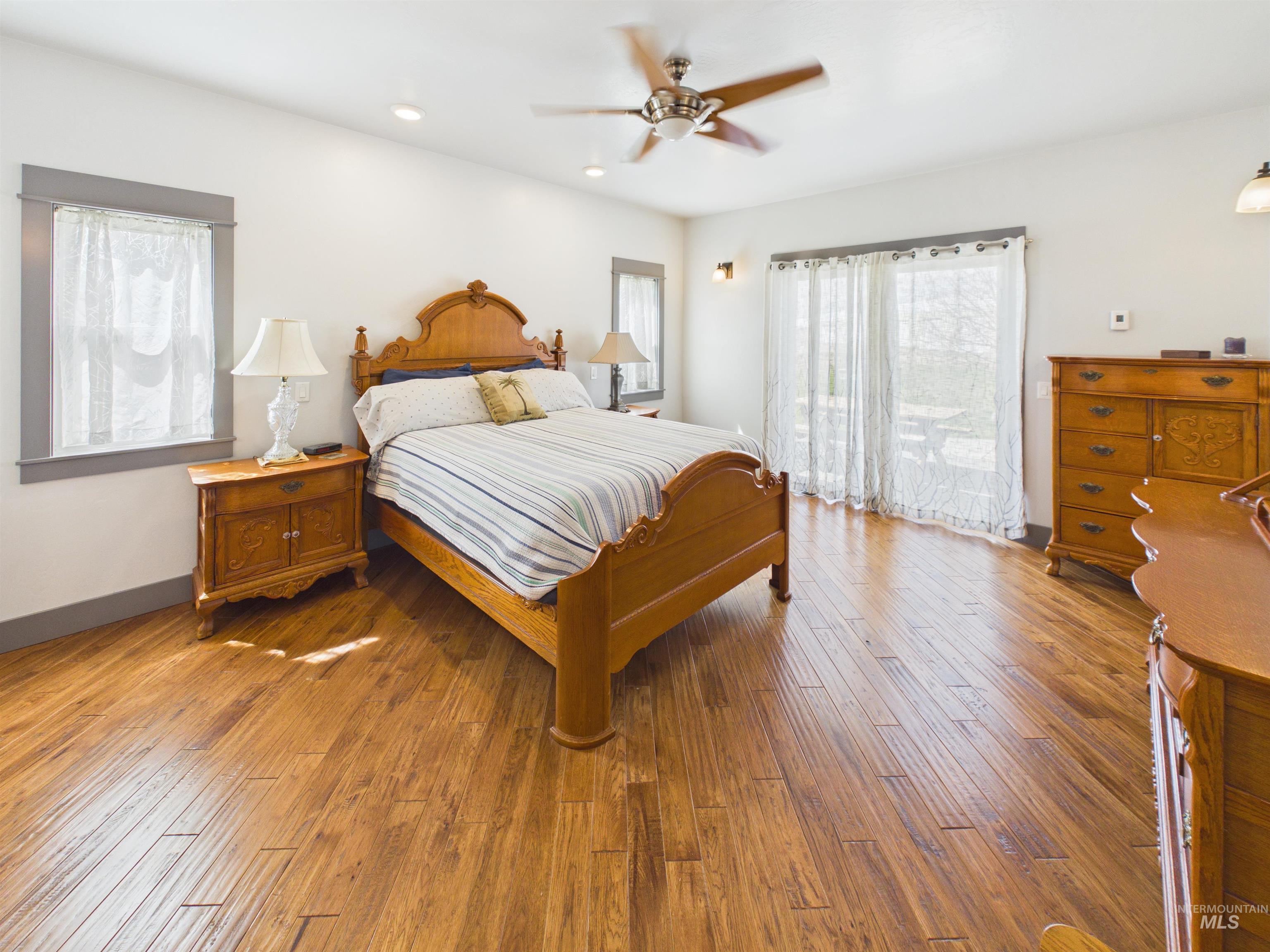 503 Heron Way Rupert, ID 83350 - Photo 16 of 49 Bedroom featuring access to exterior, wood-type flooring, a ceiling fan, and recessed lighting