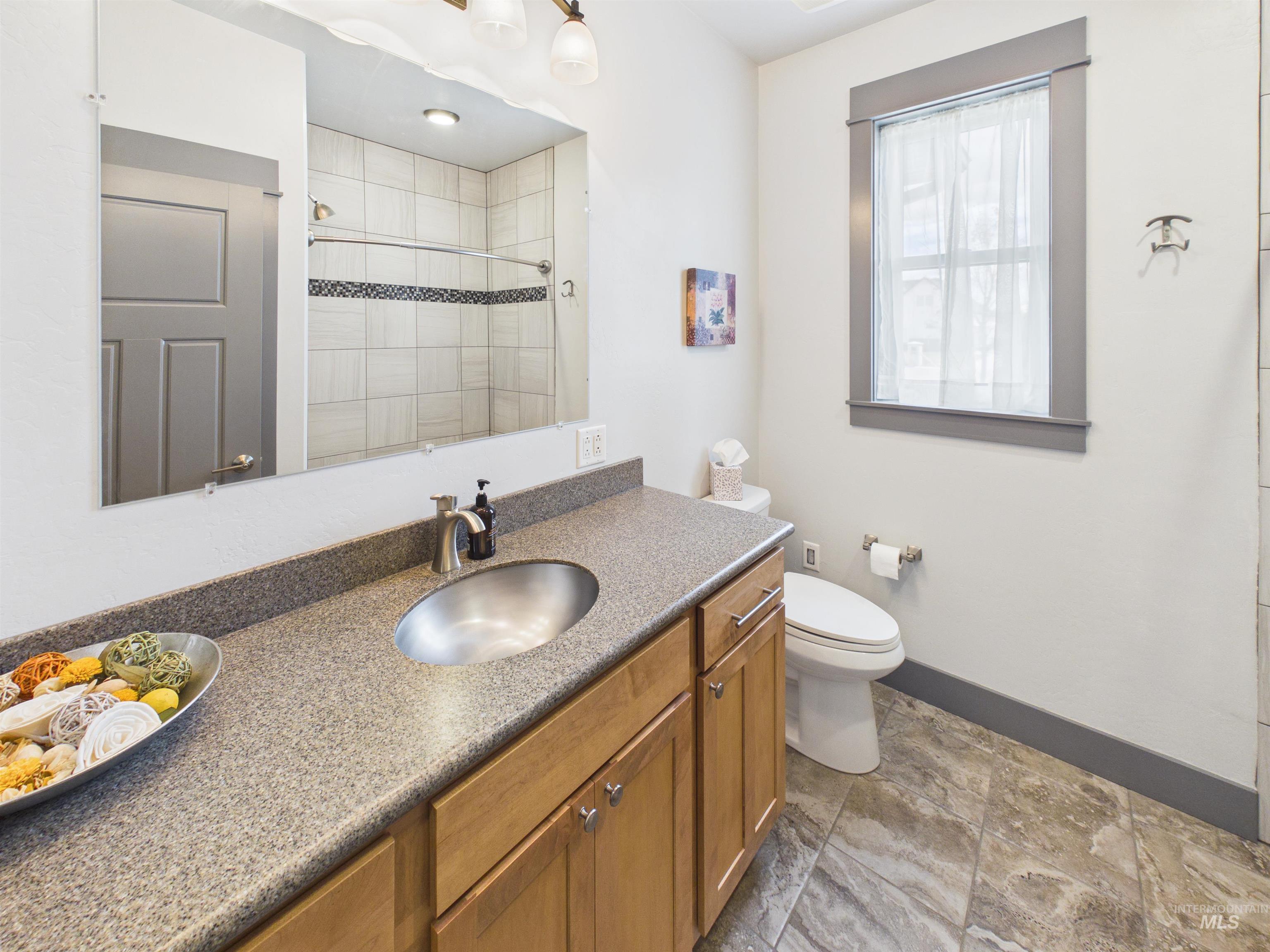 503 Heron Way Rupert, ID 83350 - Photo 24 of 49 Bathroom with vanity, a shower stall, and light stone finish floors