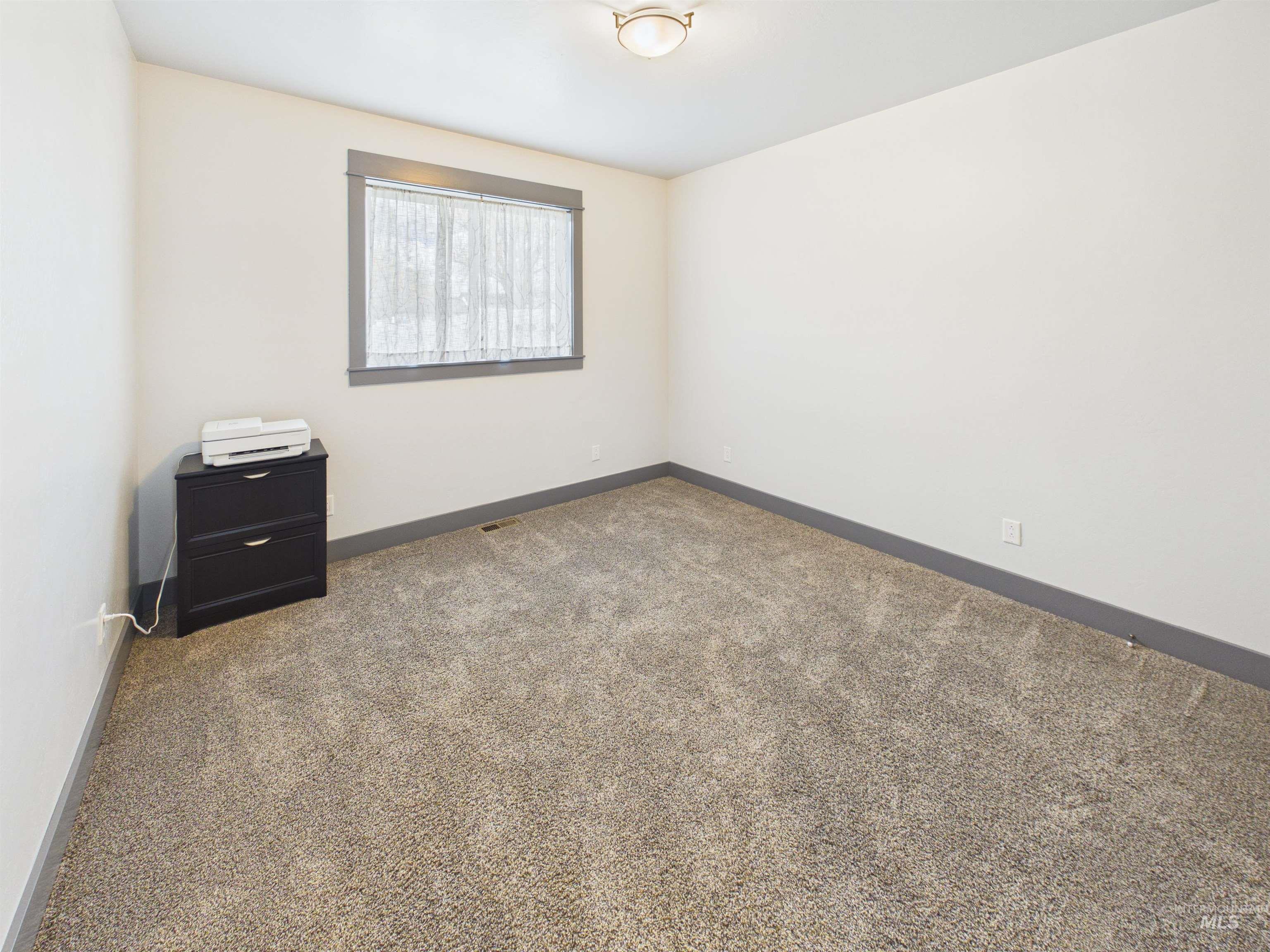 503 Heron Way Rupert, ID 83350 - Photo 27 of 49 Unfurnished room with dark colored carpet and baseboards