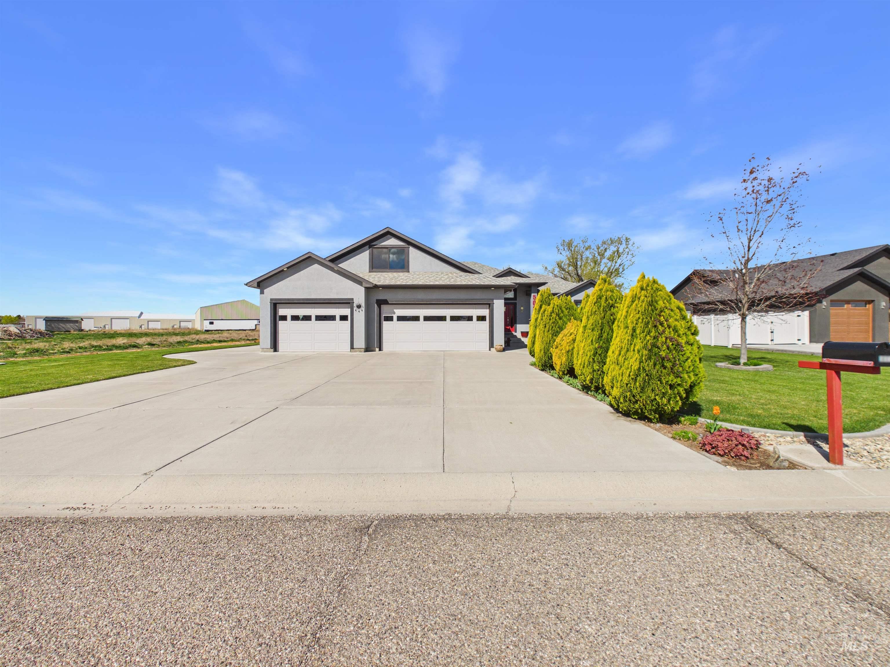 503 Heron Way Rupert, ID 83350 - Photo 3 of 49 View of front of house with a front yard, concrete driveway, and an attached garage
