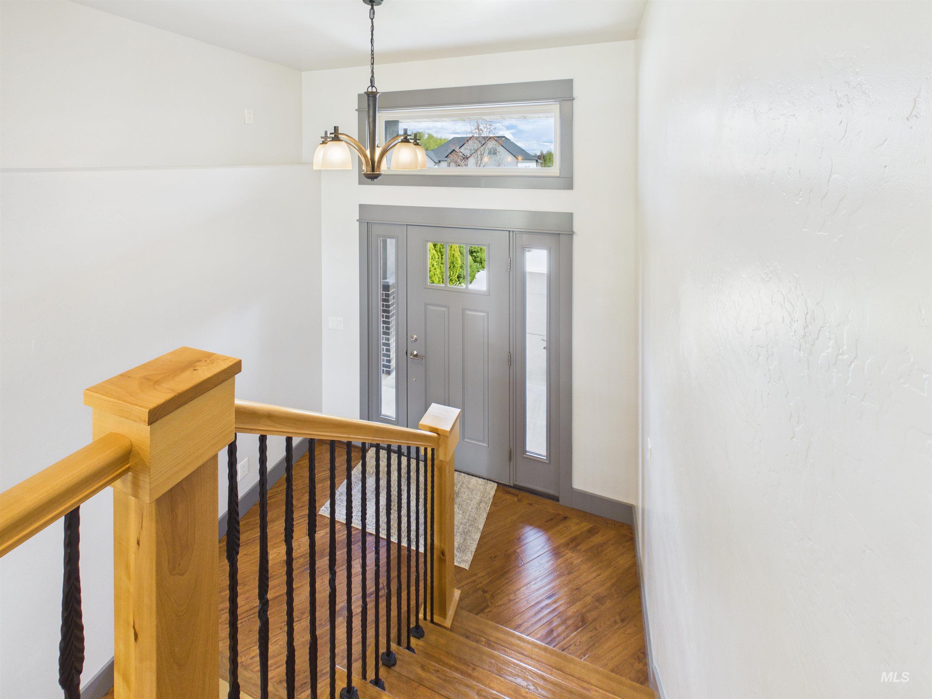 503 Heron Way Rupert, ID 83350 - Photo 31 of 49 Foyer entrance with hardwood / wood-style floors and a chandelier