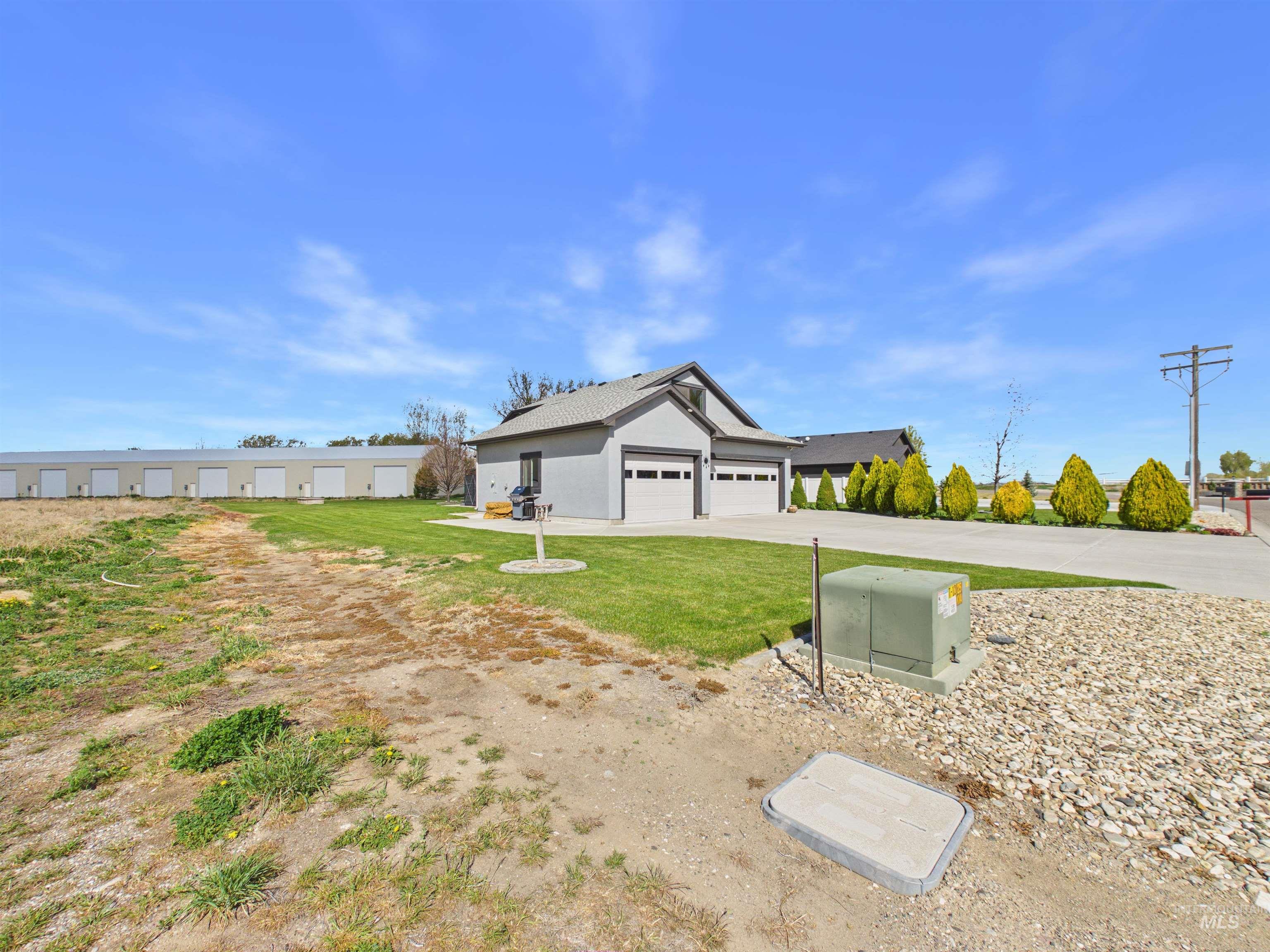 503 Heron Way Rupert, ID 83350 - Photo 4 of 49 View of front of house featuring a front yard, stucco siding, driveway, and an attached garage