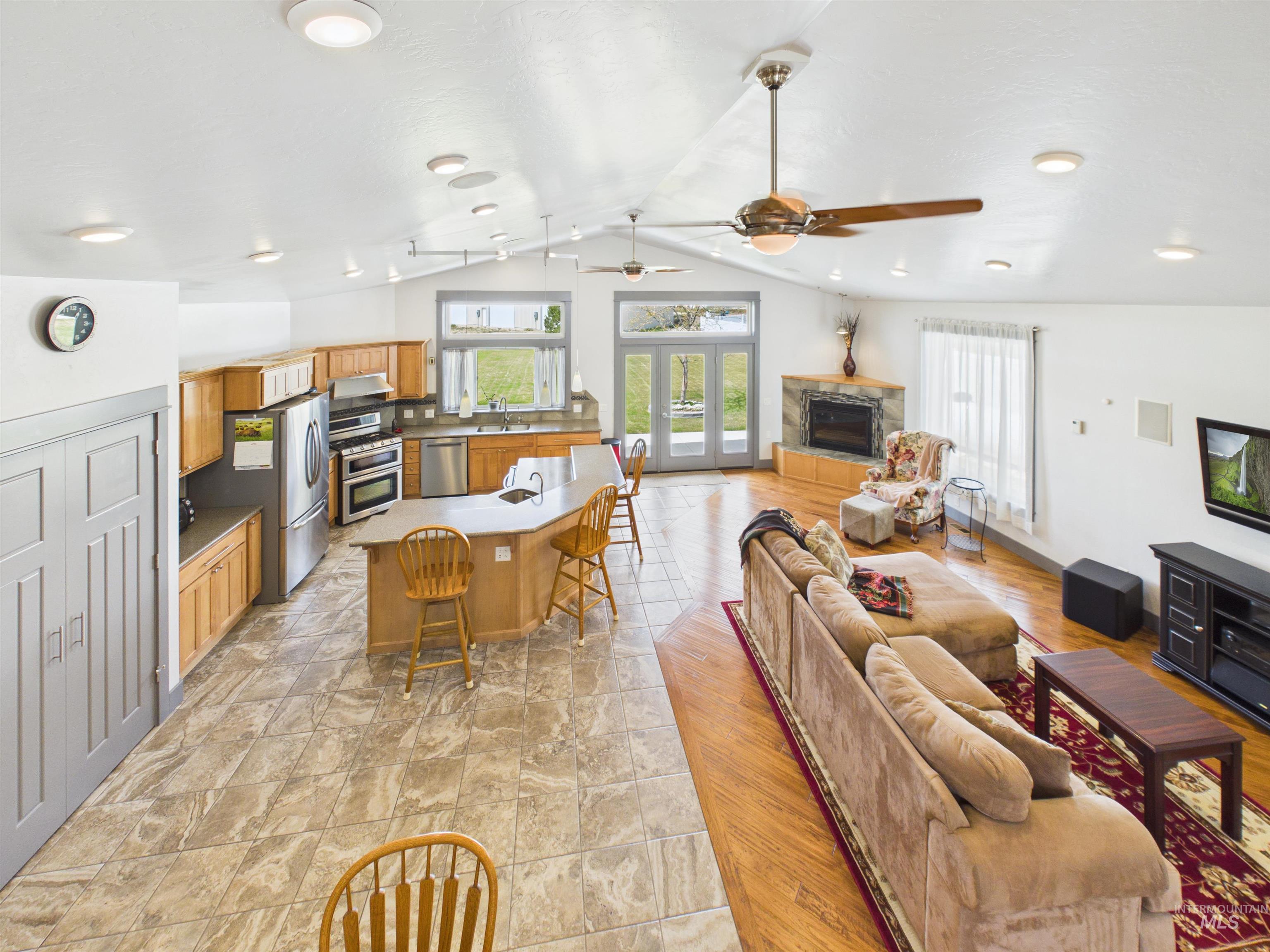 503 Heron Way Rupert, ID 83350 - Photo 40 of 49 Living room with ceiling fan, a stone fireplace, and french doors