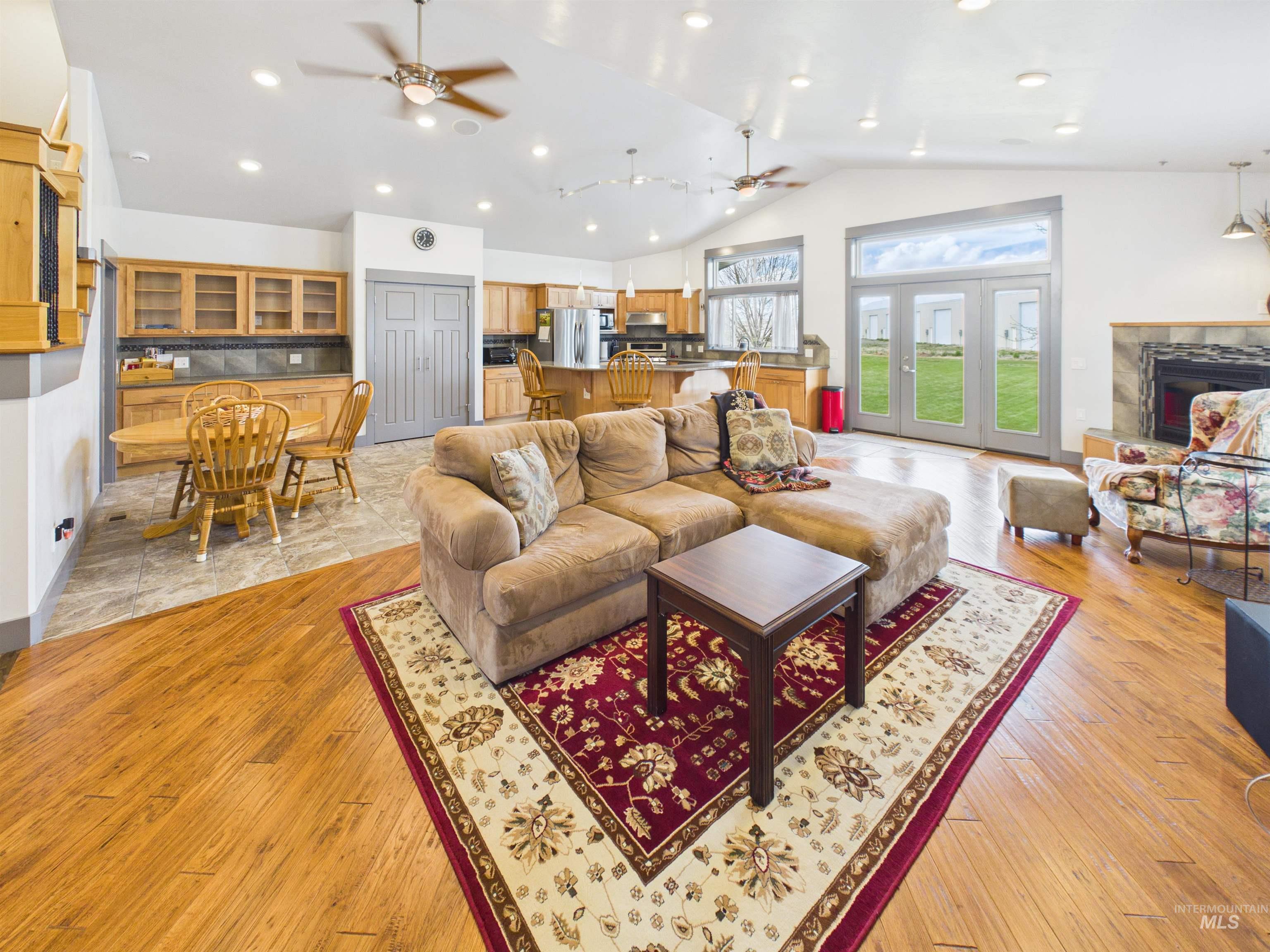 503 Heron Way Rupert, ID 83350 - Photo 8 of 49 Living room with a high ceiling, light wood finished floors, a high end fireplace, recessed lighting, and ceiling fan