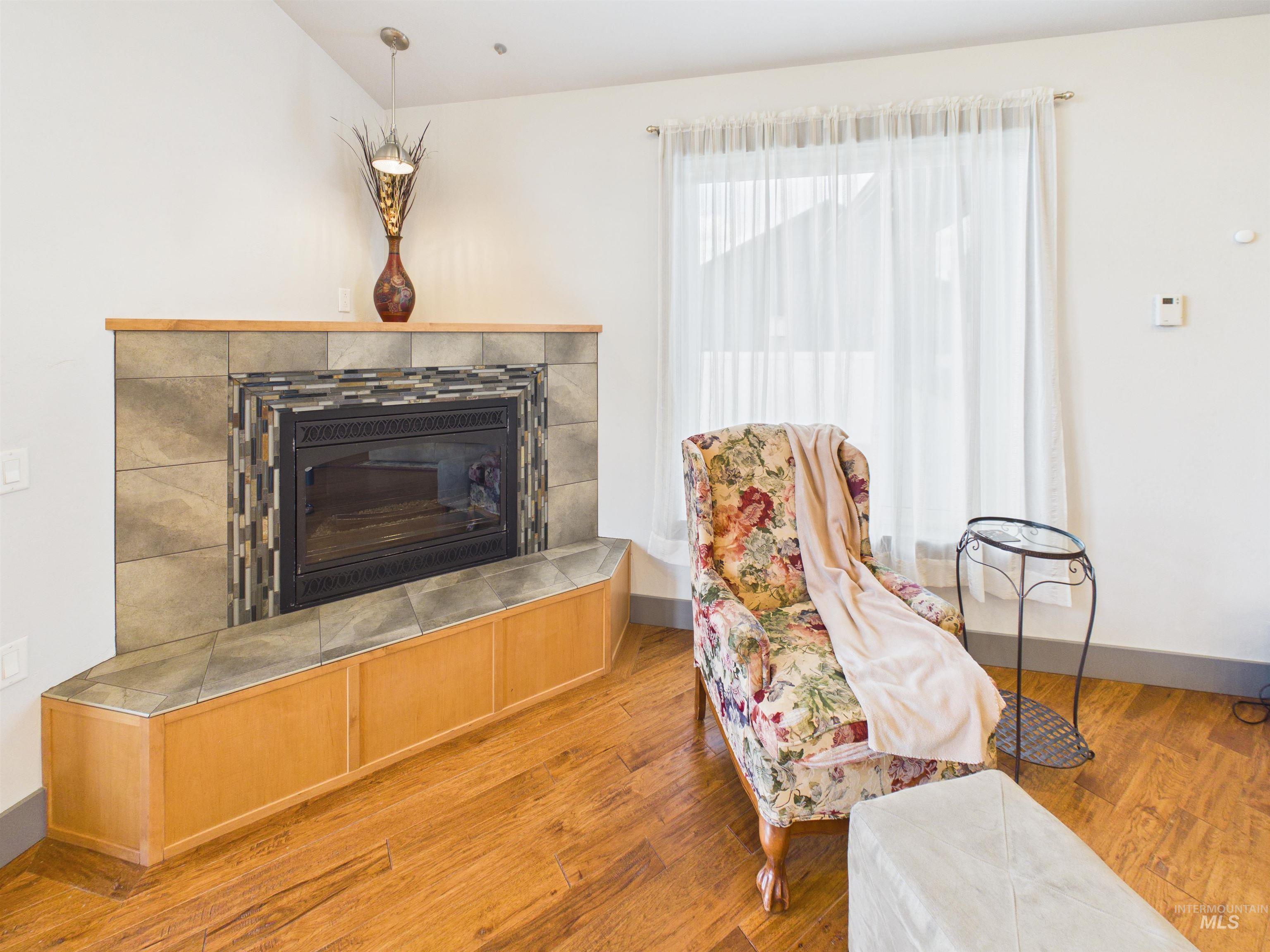 503 Heron Way Rupert, ID 83350 - Photo 9 of 49 Sitting room with wood-type flooring and a tiled fireplace