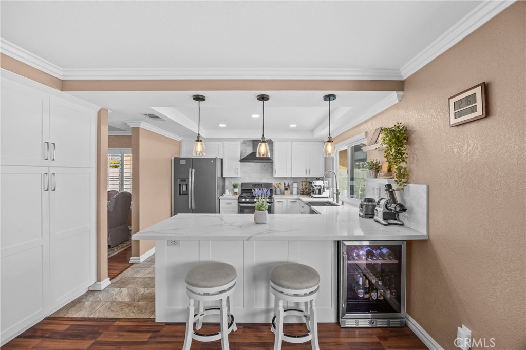 20257 Edmund Road Riverside, CA 92508 - Photo 15 of 53 a kitchen with stainless steel appliances a table and chairs in it