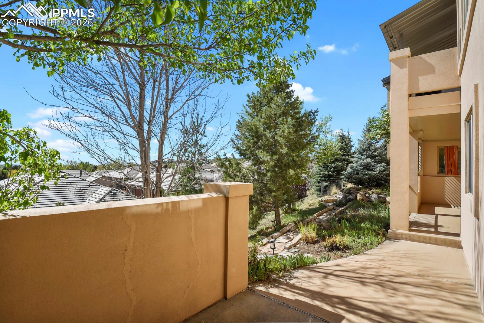 617 Concerto Drive Colorado Springs, CO 80906 - Photo 39 of 46 The property features a covered outdoor patio area with a stucco wall accessed from the basement walkout that provides a private sheltered outdoor space. Lots of trees.