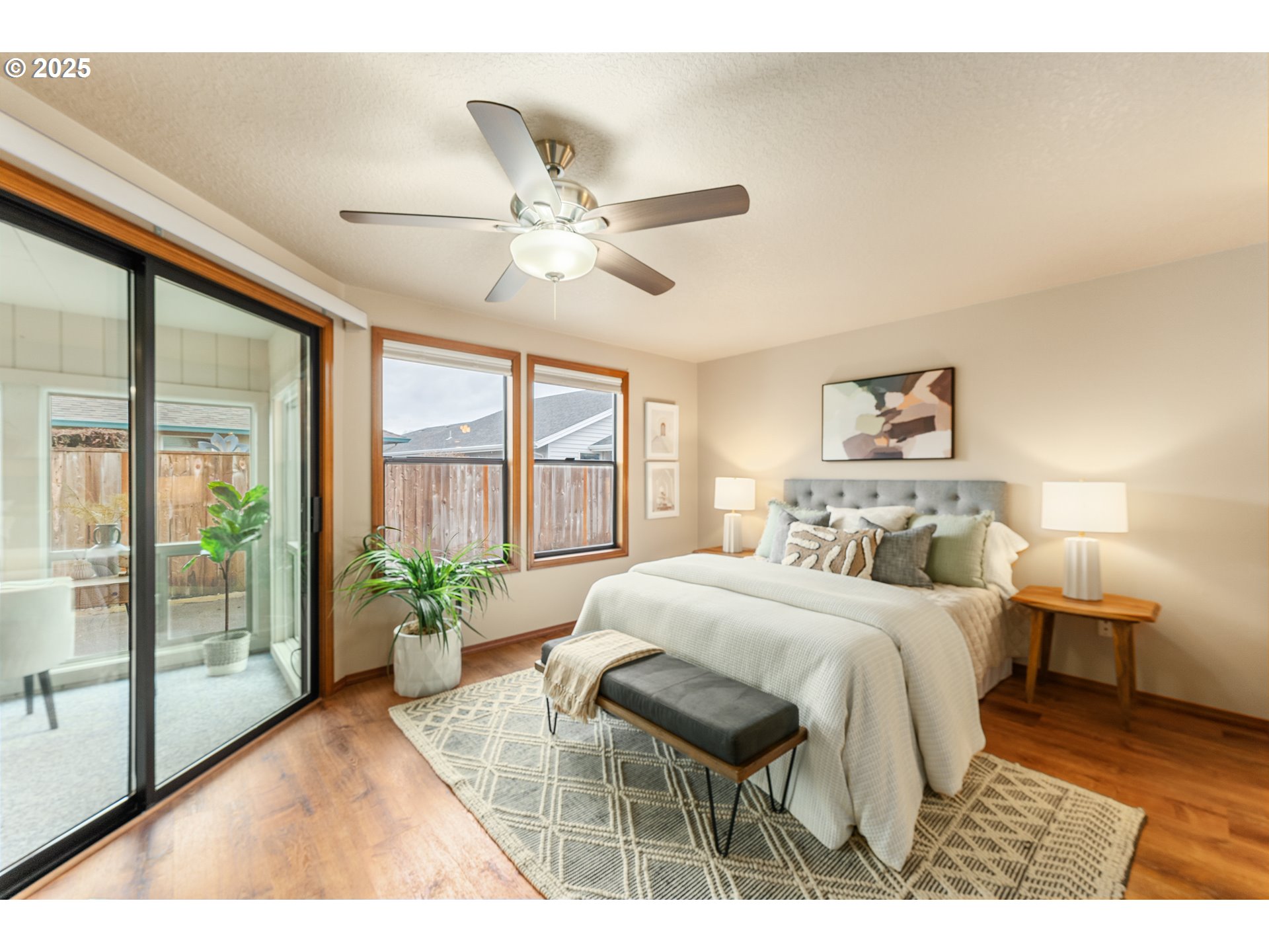 2315 Northeast 156th Place Portland, OR 97230 - Photo 13 of 25 a bedroom with a large bed and a large window