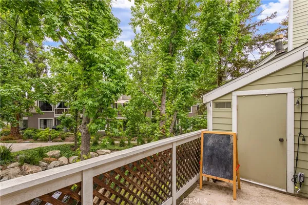 a balcony with trees in front of it