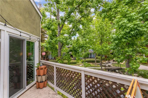 a view of balcony with wooden floor and fence