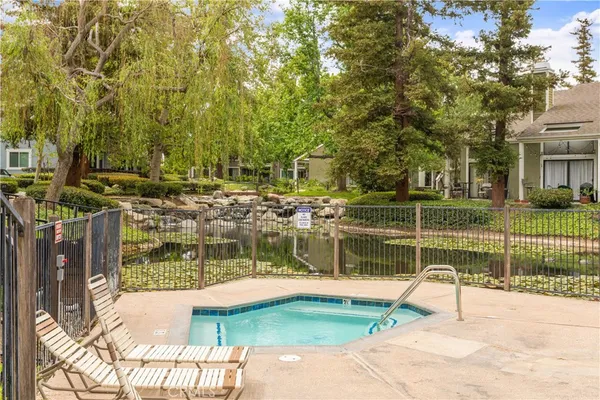 a view of a swimming pool with an outdoor space and seating area